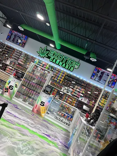 Exotics Cannabis Co. sales floor with neon sign and product displays